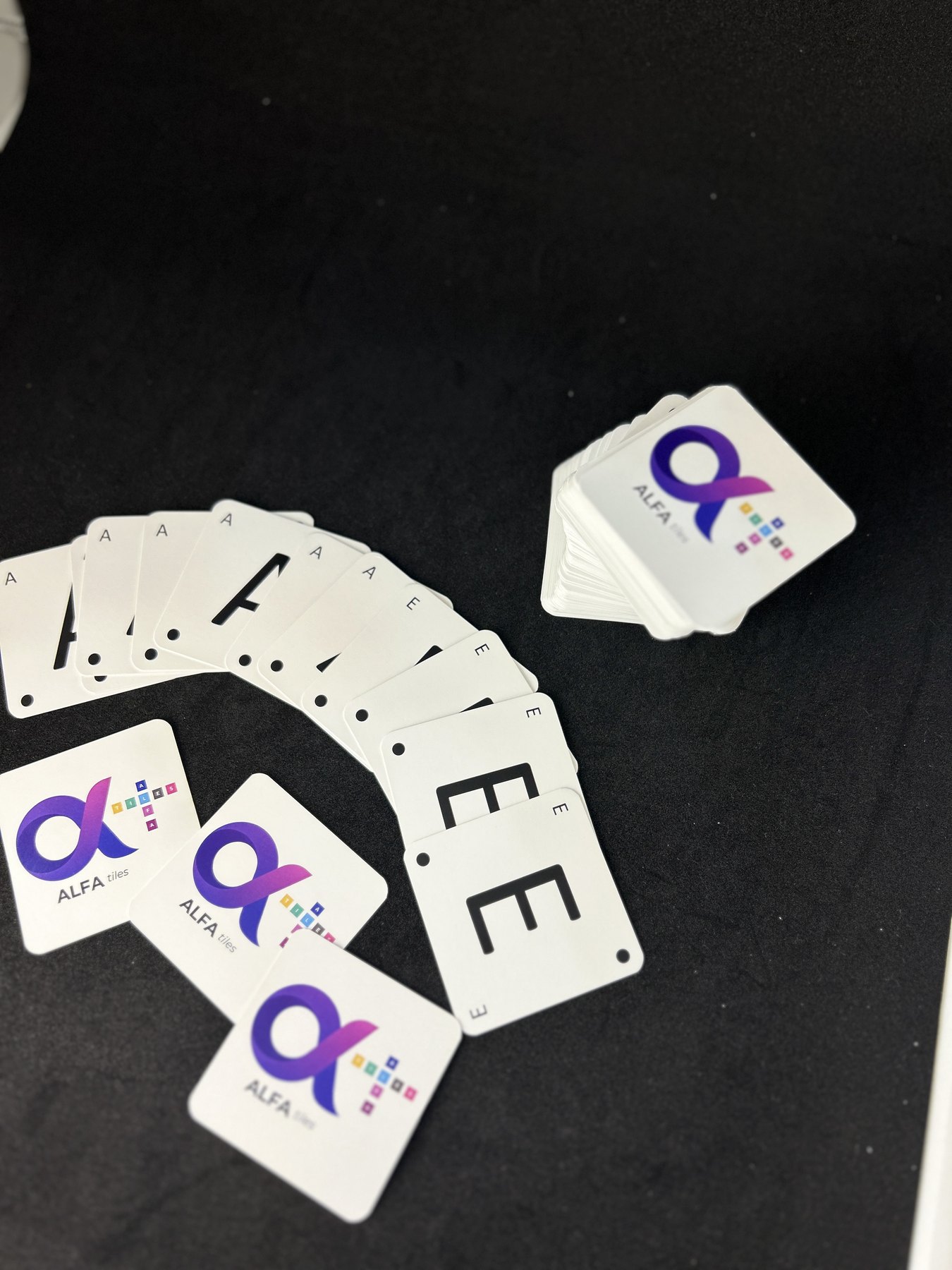Alfa Cards laid out on a dark surface