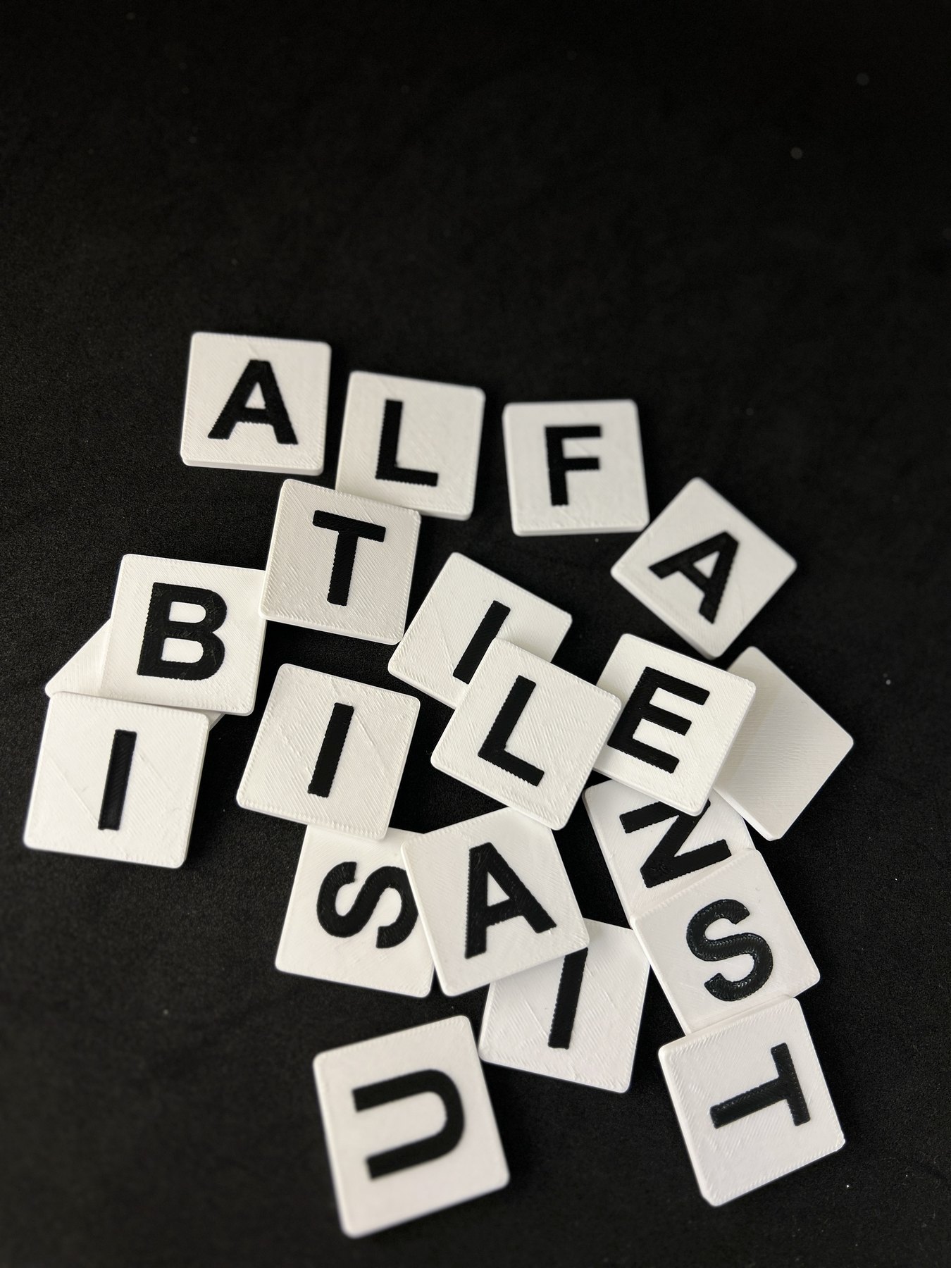Alfa Tiles arranged on a dark surface