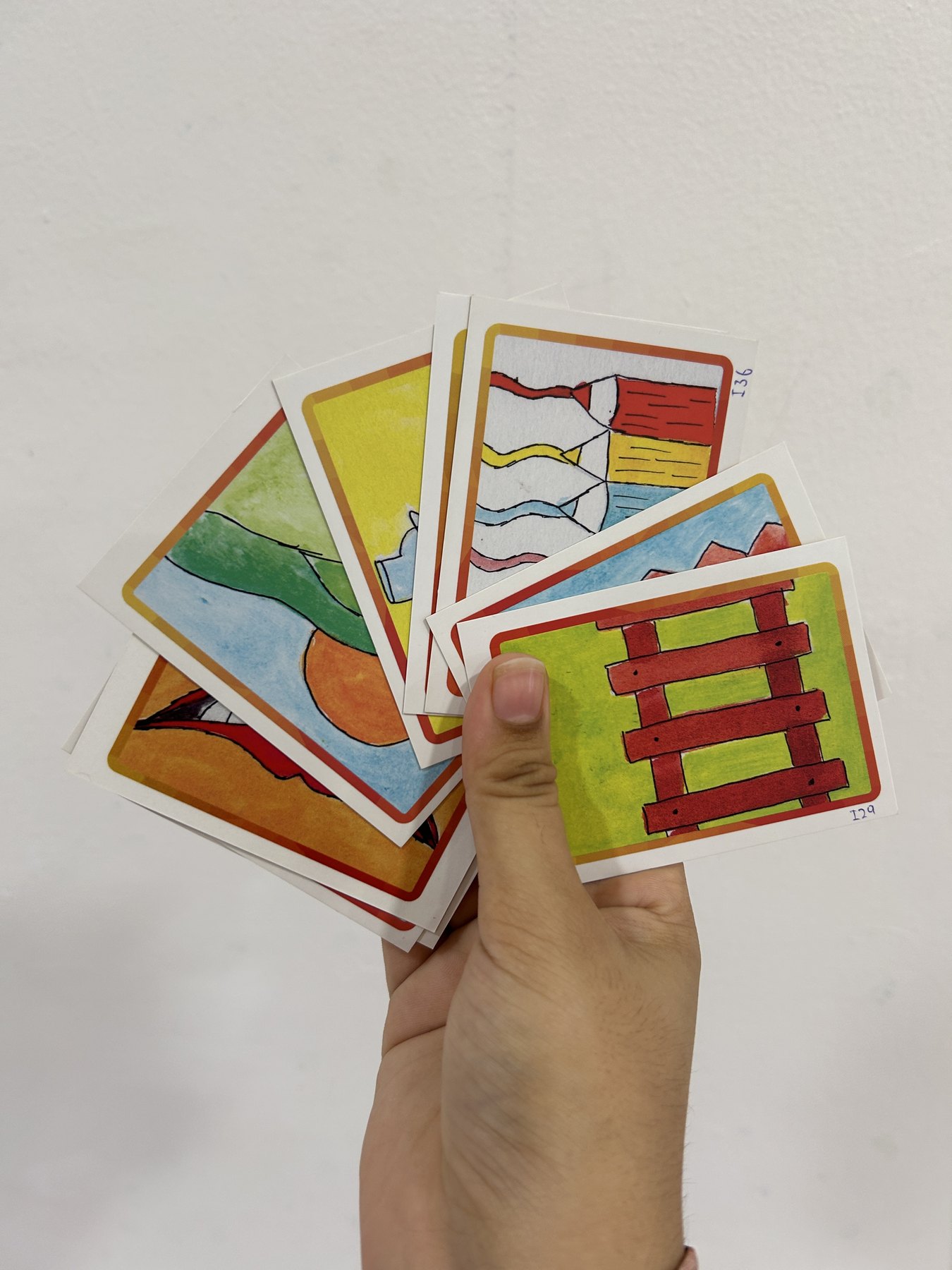 A hand holding a selection of Ti Yan cards
